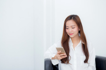 Beautiful of portrait young asian woman smiling sitting relax on the chair, girl using mobile smart phone talking enjoy, communication and social network concept.