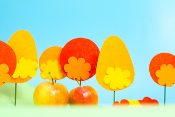 Autumn apple on the background of an orange forest
