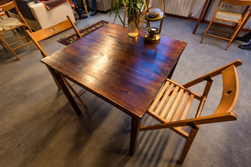 Small wooden table for two in restaurant