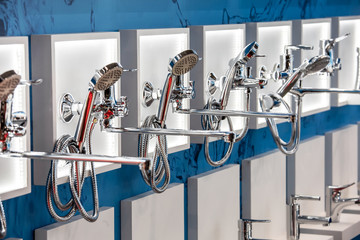 Variety of modern chrome and silver metal shower heads in the shop