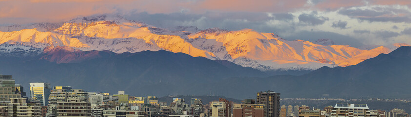 Amazing views of Santiago de Chile city during the sunset with the Andes mountain range making a...