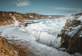 Huge waterfall Gullfoss (Golden Fall) in the morning mist. Colorful winterscene on Hvita river in...