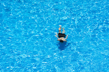 Children diving in a pool in summer