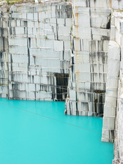 Mine quarry, block of granite with an amazing aqua color lake in the bottom