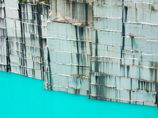 Mine quarry, block of granite with an amazing aqua color lake in the bottom