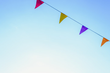 Colorful pennants with sky background to place text