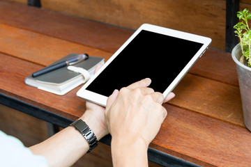 man using tablet computer with blank screen