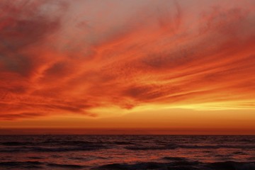 Fototapeta na wymiar crimson red sunset over the ocean 
