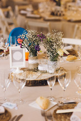 Decoration of the centerpieces of a wedding with the cutlery and vintage details.