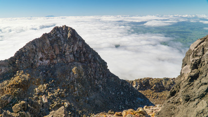 Above clouds after hard hike to the top of Mt. Taranaki, New Zealand
