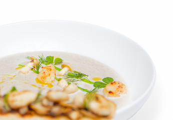 Cream mushroom soup with scallops and some herbs.
