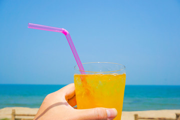 Orange juice drinking on the beach. ビーチで飲むオレンジジュース