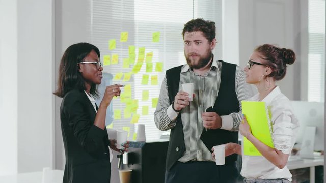 Workers of business center talk about vacation