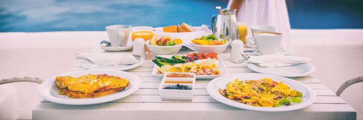 Breakfast brunch travel vacation hotel table with view of Mediterranean sea in Santorini, Greece,...
