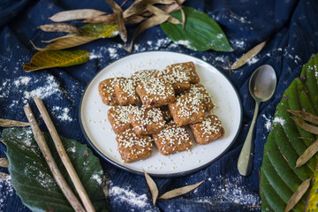 Homemade halva - sweet confections dessert made with tahini (sesame paste) nuts, butter, sunflower seeds, dates, honey, herbs, spices, oil. Vegan sweets. Vegetarian dessert. Arabic Turkish halava