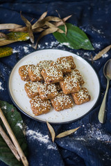 Homemade halva - sweet confections dessert made with tahini (sesame paste) nuts, butter, sunflower seeds, dates, honey, herbs, spices, oil. Vegan sweets. Vegetarian dessert. Arabic Turkish halava