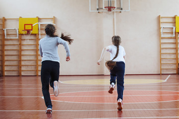 Primary school children a sport lesson indoors