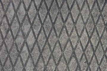 Texture of a diamond-shaped concrete surface. Reinforced concrete slab.