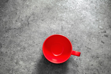Red coffee mug on a dark background