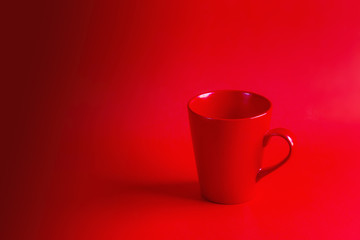 Red coffee cup on a red background
