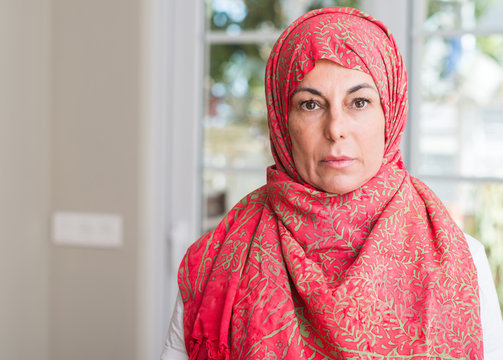 Middle aged muslim woman wearing hijab with a confident expression on smart face thinking serious