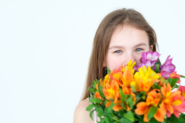 Fototapeta premium little girl with a flower bouquet gift. tender floral alstroemeria composition for mothers or womens day.