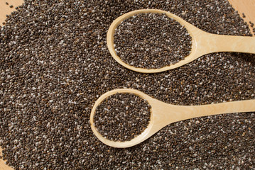 Healthy Chia seeds in a wooden spoon on a wooden table