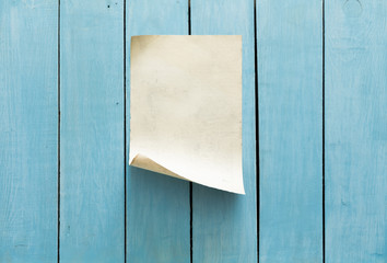 old paper on blue wall