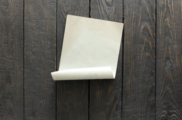 old paper on dark wooden wall