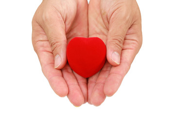 Obraz premium Hands holding small gift heart on Valentine's Day isolated on white background.