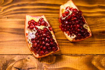 Pieces of the garnet fruit on wooden table