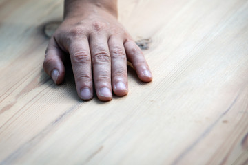 worker's hand on a wooden background. free space for text or advertisement