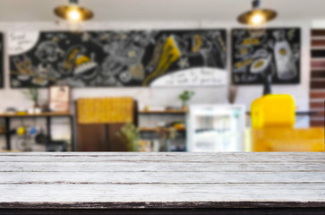 Selected focus empty brown wooden table and Coffee shop or restaurant blur background with bokeh image. for your photomontage or product display