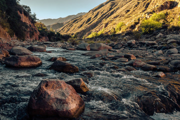 Rocks at the river sunset
