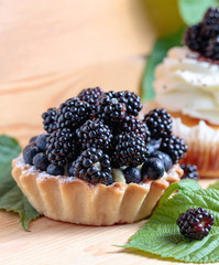 Tasty blackberry cakes with berries and cream.