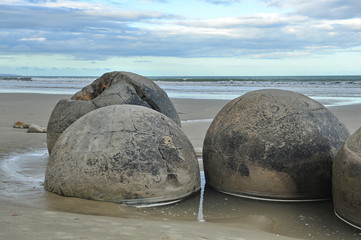 Fototapeta na wymiar Stone balls on a sandy beach in New Zealand