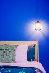 Vintage ceiling lamp on blue bedroom wall