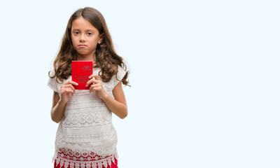 Brunette hispanic girl holding passport of Switzerland with a confident expression on smart face thinking serious