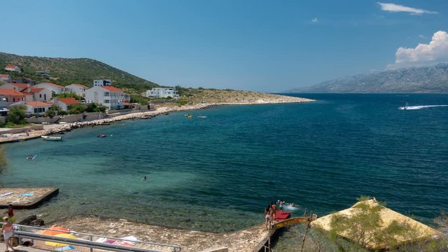 Timel lapse and left to right pan of beach Vinjerac, small traditional fishing town in Croatia