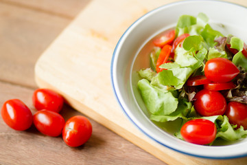 Healthy eating with delicious vegetable salad bowl at home. Vegetarian, kitchen and cooking concept.