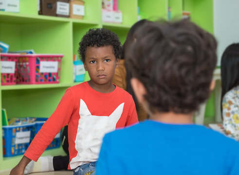 African american boy angry and looking at friend in school library in kindergarten.kids education concept.