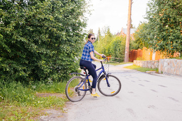 Fototapeta premium Young woman riding a bike