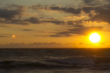 Sunset and waves on the beach