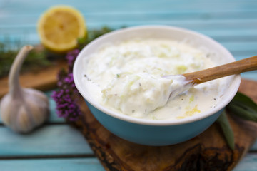 Traditional Greek tzatziki sauce and ingredients for the recipe.
