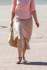 Women's feet in sandals in the city
