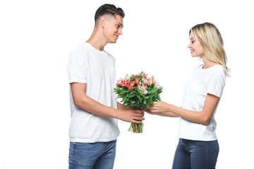 side view of boyfriend presenting bouquet to girlfriend isolated on white