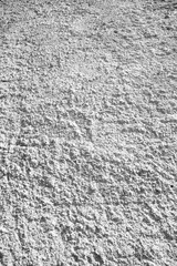 Black and white abstract vertical wall surface. Texture with roughness and detail grain