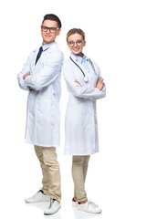 doctors standing with crossed arms and looking at camera isolated on white