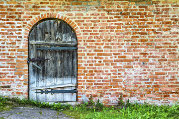 Old wooden door in a brick building