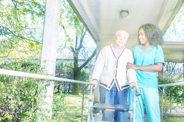 Obraz premium African nurse helping elderly man with walker in rehab facility hallway